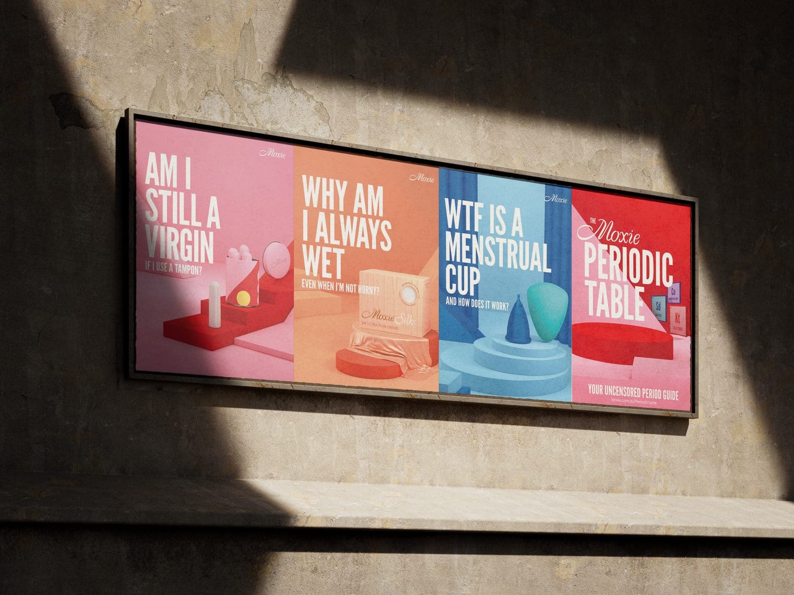 Four Moxie posters in a frame on a concrete wall: Am I still a virgin if I use a tampon?, Why am I always wet even when I'm not horny?, WTF is a menstrual cup and how does it work?, and The Moxie Periodic Table, your uncensored period guide