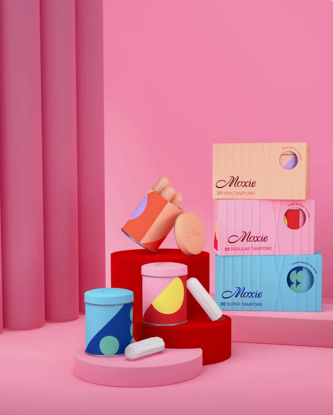 Moxie tampon tins and boxes of mini, regular and super tampons stacked on red and pink plinths