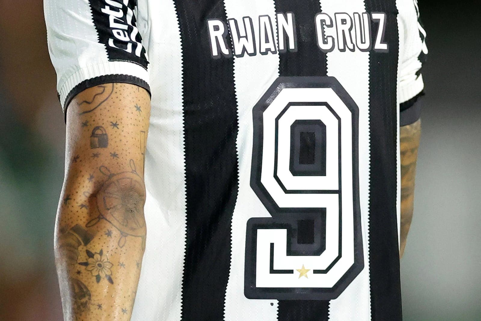 Close-up of the back of Rwan Cruz’s black and white striped number 9 shirt